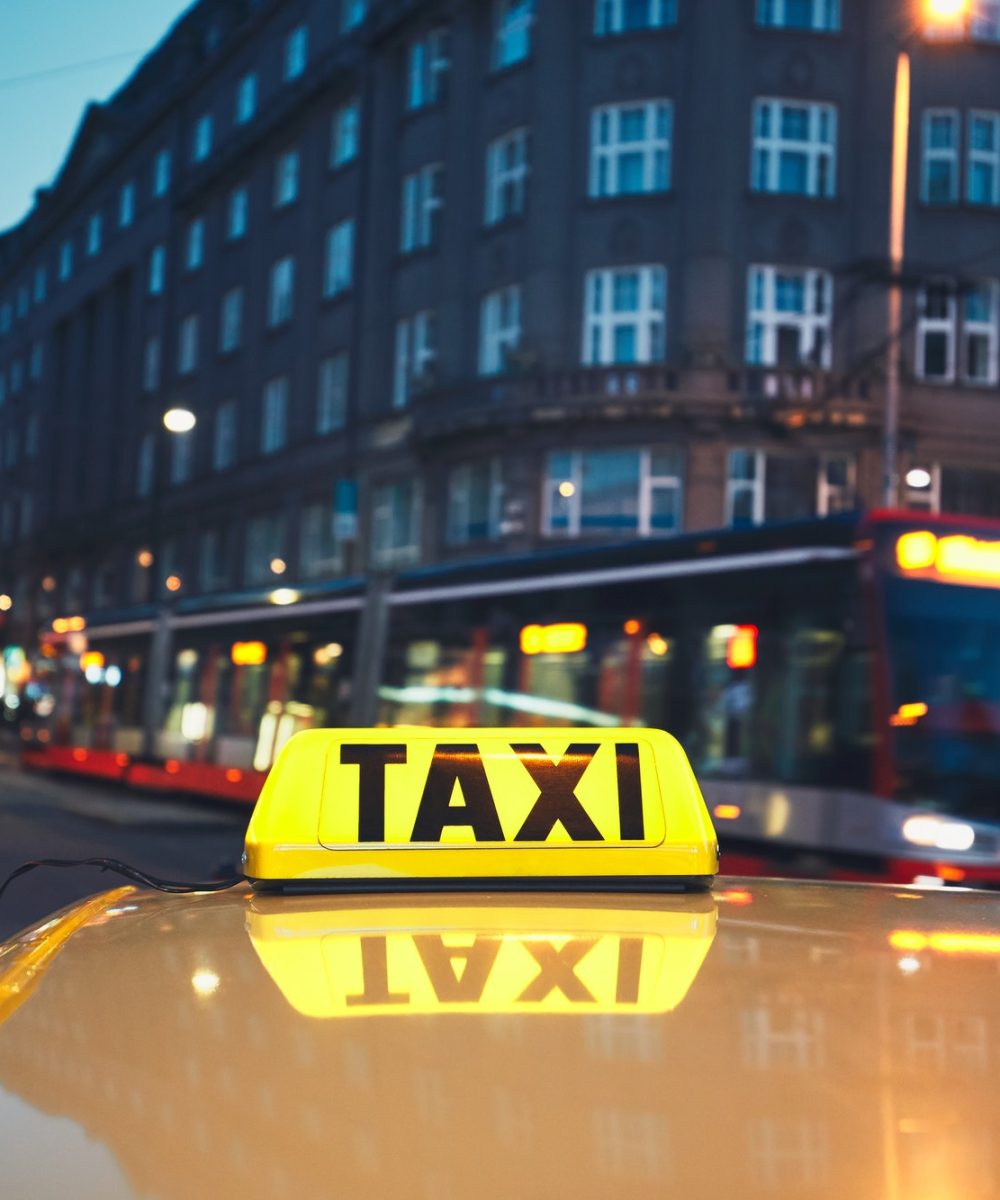 taxi-car-and-tram-of-public-transportation-on-the-city-street-at-night.jpg